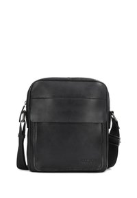 Borsa a tracolla in pelle nera con una texture liscia, dotata di una chiusura a patta e di una tracolla regolabile. Branding evidente sulla parte anteriore.