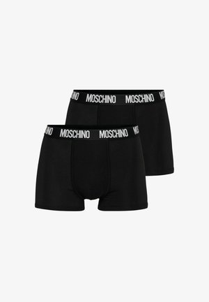 Due boxer da boxer Moschino neri con fascia elastica bianca con il marchio, disposti uno accanto all'altro su uno sfondo bianco.