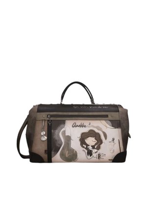 Borsa da viaggio rettangolare marrone e beige con manici neri, tasca con cerniera e illustrazione di una bambina dei cartoni che tiene un uccello con il nome Anekke.