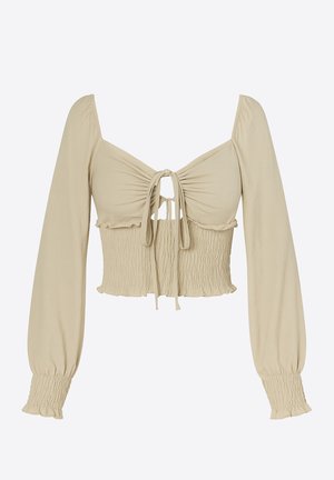Lichtbeige cropped top van gladde stof; heeft lange, pofmouwen, een geraffineerde buste met een strik aan de voorkant en een gerimpelde textuur aan de taille.