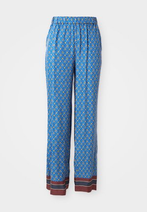 Blå mønstrede bukser med en diamantmotif i gule og hvide accenter. Har elastisk talje og brun kant ved nederste del.