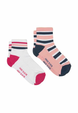Two pairs of ankle socks, one white with pink and black stripes and accents, one pink with black and white stripes and accents.