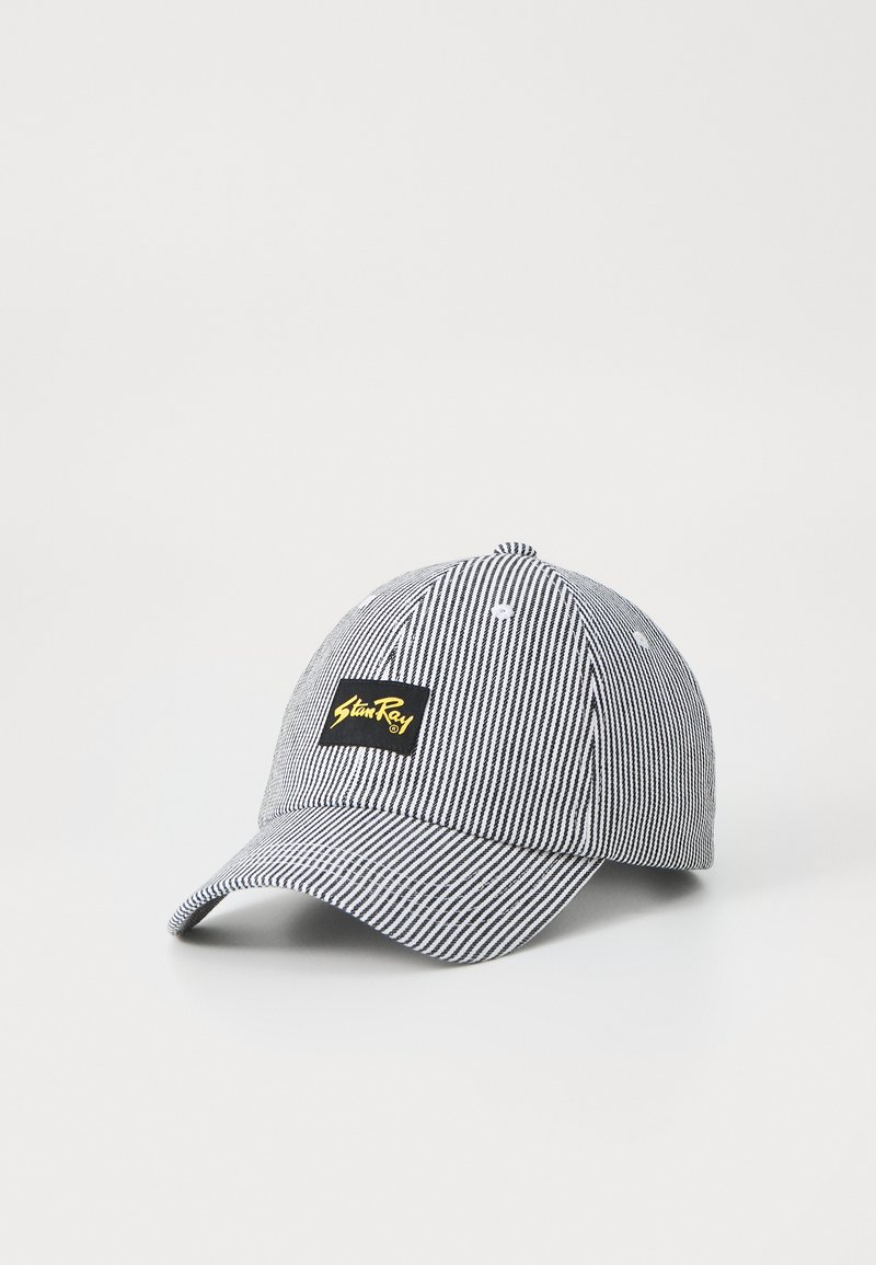 Black and white striped cap made of cotton with a curved brim, featuring a rectangular logo patch in yellow and black on the front.