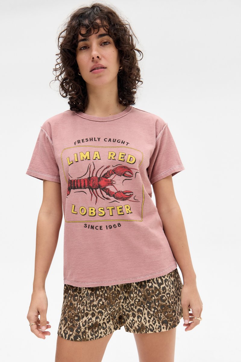 Light pink cotton t-shirt featuring a lobster graphic with “LIMA RED LOBSTER” text, paired with leopard print shorts for a contrasting pattern.