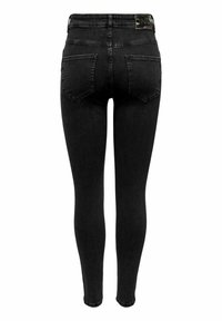 Jeans ajustados de mezclilla negra con una cinturilla alta y bolsillos traseros. Textura suave con un hardware mínimo, con una etiqueta de logo en la cintura.