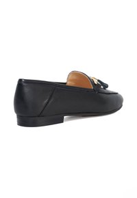 Black leather loafers with a flat heel, featuring a tassel detail on the front and smooth texture, designed for casual wear.