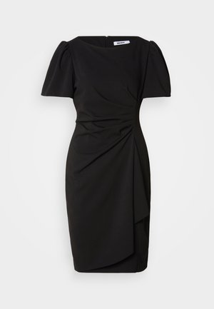 Fekete, testhez simuló ruha rövid puffos ujjakkal, elülső redőzéssel és aszimmetrikus alsó résszel. Hátul cipzáras záródás. Simaságot sugalló szövettextúra.