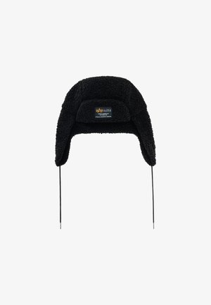 Black sherpa trapper hat with ear flaps and front patch label reading Alpha Industries.