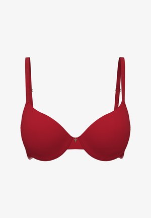 Červená polstrovaná podprsenka s hladkými košíčky a nastavitelnými ramínky. Uprostřed dekorativní ozdoba a krajková lemovka na spodním pásu.