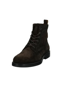 Brown suede ankle boots with a round toe, laced front, stitching details, and a black rubber sole. Features a pull tab at the back.