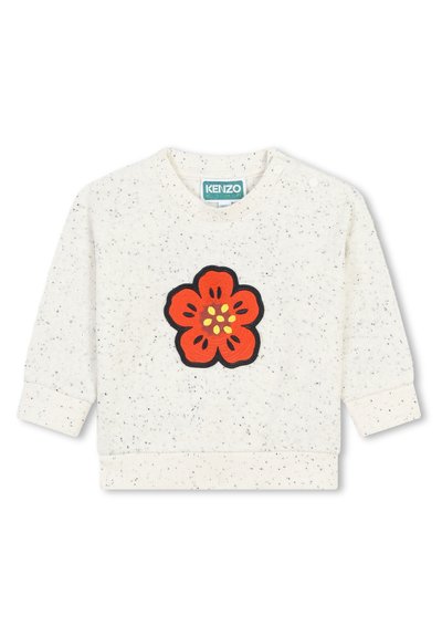 Sweatshirt crème avec broderie de fleurs noires et rouges sur le devant, présentant une texture mouchetée et des poignets et un ourlet côtelés.