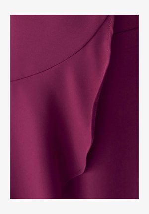 Tessuto viola scuro con una texture liscia e pieghe curve e sovrapposte che creano morbide ombre e riflessi.