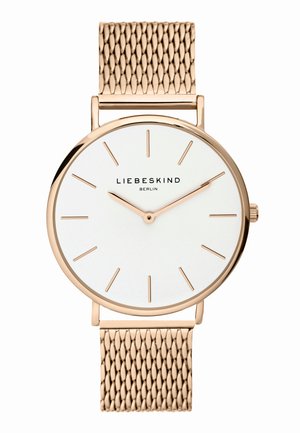 Montre avec un bracelet en maille rose gold, un cadran rond blanc, des marqueurs d'heure minimalistes et des aiguilles. L'arrière présente une finition polie. Le nom de la marque est affiché.