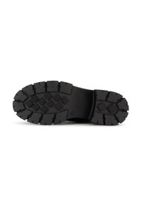 Black rubber sole with deep treads, featuring diamond patterns and ridges for traction. Flat heel and smooth surface.