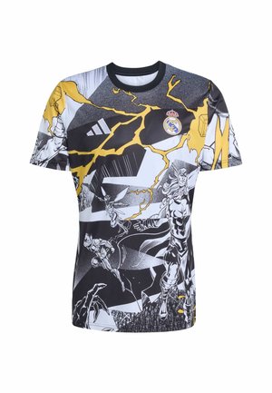 Maglietta grafica con colori nero, bianco e giallo. Il design include illustrazioni in stile fumetto e il logo del Real Madrid sul petto.