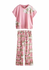 Pink floral lounge set featuring a short-sleeve top with a smooth texture and loose fit, paired with matching elastic waist pants, both adorned with white blossoms.