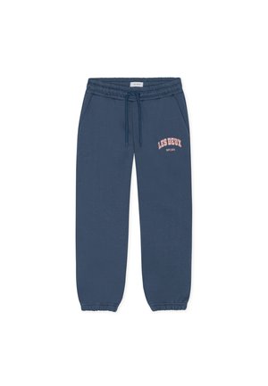 Siniset puuvillaiset collegehousut, joissa on joustava vyötärönauha ja kiristysnyöri. Housuissa on sivutaskut ja etupuolella vaaleanpunainen "LES DEUX EST. 2011" -logo.