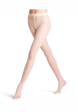 Legs wearing sheer nude tights with small white crosses, one foot flat and the other raised, on a white background.