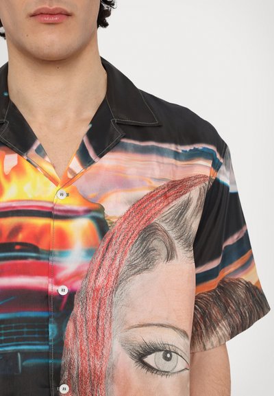 Short-sleeve shirt featuring a glossy fabric with a colorful graphic design, prominently displaying a face with red hair and large eye details.