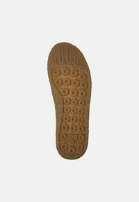Suola di scarpa in gomma, colore beige chiaro, superficie testurizzata con motivi circolari e scanalature per la trazione. Include etichetta del marchio con la taglia.