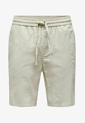 Jasno beżowe szorty wykonane z miękkiego materiału, z elastycznym pasem oraz sznurkiem do regulacji, bocznymi kieszeniami i luźnym krojem.