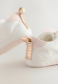 Sneaker bianchi in pelle con accenti rosa, motivo floreale in rilievo e linguetta sul tallone in shiny rose gold. Suola testurizzata per una buona aderenza.