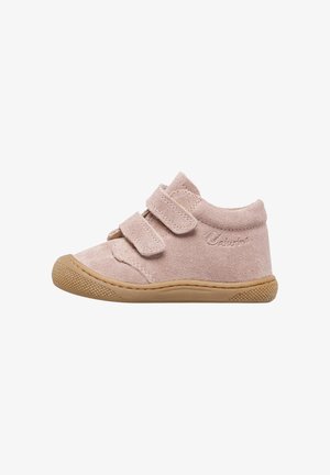 Light pink suede shoe with two Velcro straps, round toe, and rubber sole featuring a textured pattern for added grip.