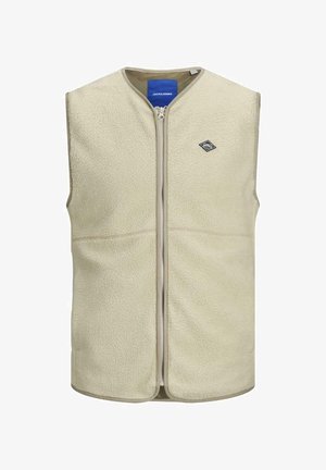 Veste sans manches en polaire beige clair avec un col rond, une fermeture éclair frontale et un petit écusson logo sur la poitrine gauche. Texture douce et design sans manches.