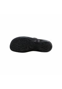 Black rubber shoe sole with intricate swirling patterns, smooth texture, and a slim, curved shape designed for grip and comfort.