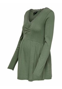 Dugih rukava, rebrasto majica za majke, u maslinasto zelenoj boji s V-izrezom i nakupinama na bustu. Valoviti obrub duž izreza.