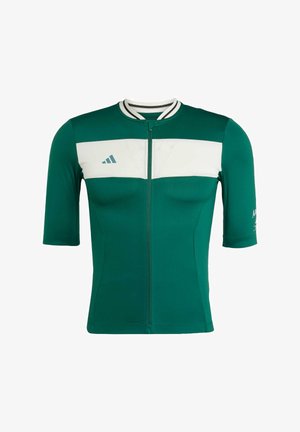 Maillot vert à manches courtes en matériau respirant, avec un panneau poitrine blanc, une fermeture éclair, un col rayé et un détail de logo.