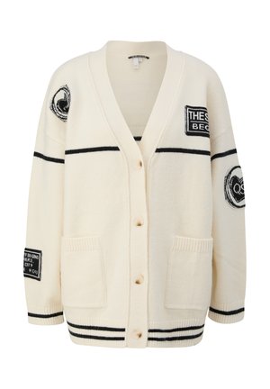 Cream cardigan with black stripes, button closure, patch pockets, and multiple black and white graphic patches on sleeves and chest.