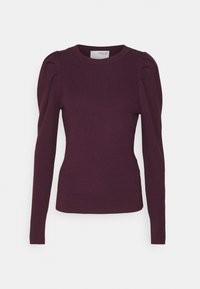 Mörklila räfflad tröja med långa ärmar, rund halsringning och puffiga axelaccenter. Mjuk textur med en figurnära passform.