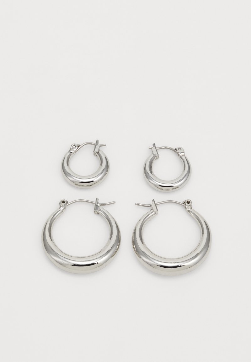 Silver hoop earrings, featuring two sizes. Smooth texture, rounded design, and a polished finish with secure hinge closures.