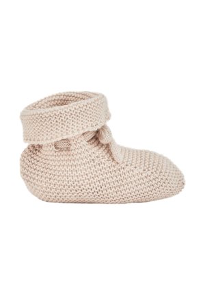 Chausson bébé tricoté beige doux avec revers plié et petit détail nœud, présenté de côté sur fond blanc.