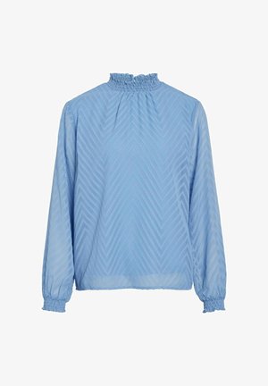 Hele sinine pluus kõrge volangkaeluse ja pikkade varrukatega, millel on tekstuuriga chevron muster. Elasticiseeritud mansetid ja lõtv istuvus.