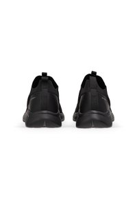 Svarta löparskor med övre i mesh, texturerad gummisulor och dragflikar bak. Minimalistisk design; inga synliga logotyper eller mönster.