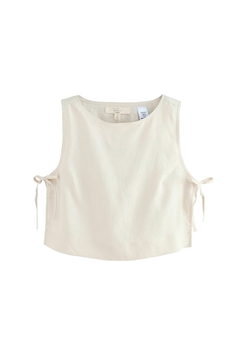 Top sans manches en lin beige clair, avec un col rond et des accents de liens ajustables sur les côtés pour un ajustement personnalisable.