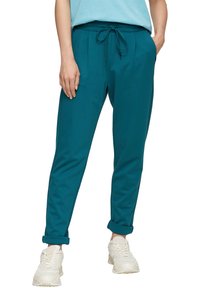 Turkusowe spodnie sportowe z elastycznym pasem, detalem w postaci sznurka i podwiniętymi mankietami. Wykonane z gładkiego, lekkiego materiału.