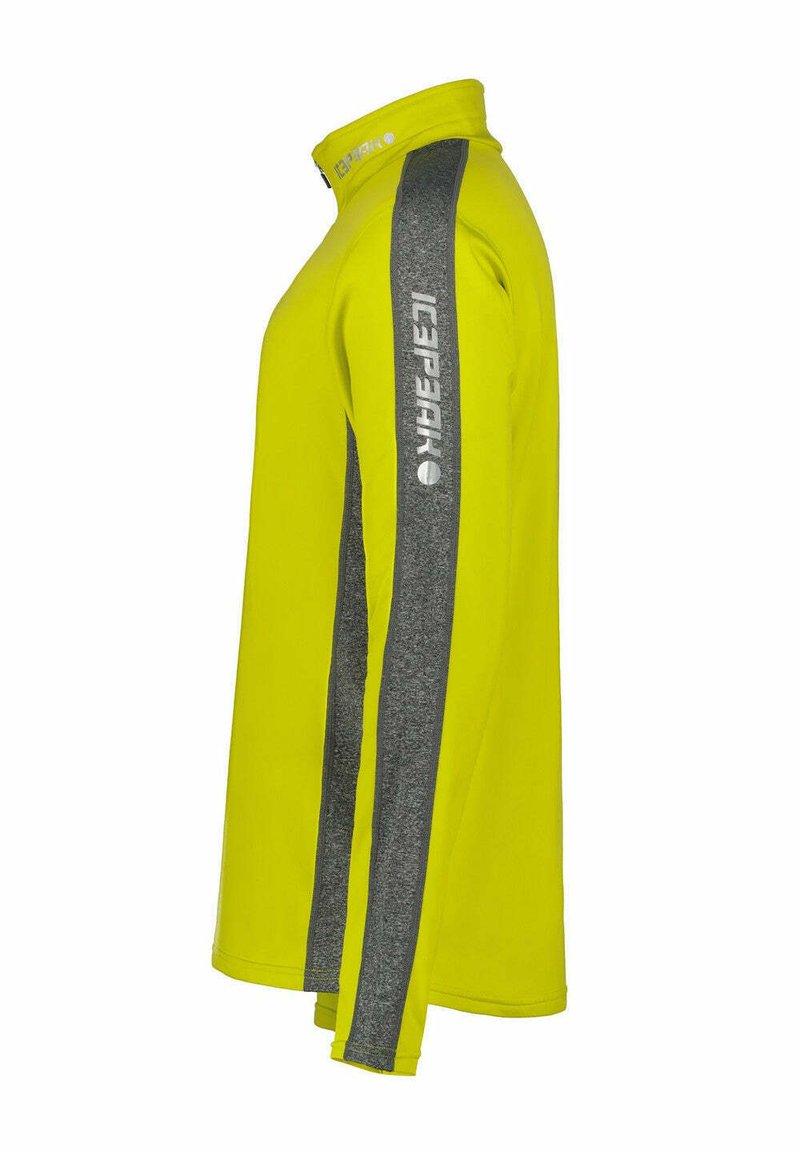 Langärmliges Sporthemd, leuchtend gelber Stoff mit Stehkragen, grauen Seitenstreifen und Logodetails entlang des Ärmels. Glatte Textur.