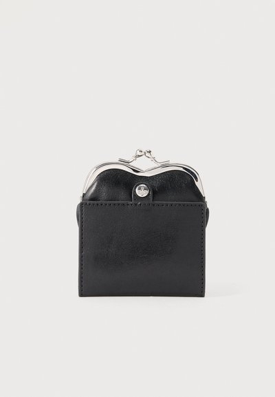 Compact black leather coin purse with silver clasp and smooth rectangular front pocket against a white background.