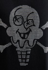 Black fabric t-shirt featuring a design of a skull-shaped ice cream cone in silver rhinestones, with crossbones beneath the cone.