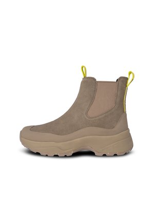 Brown suede ankle boots with elastic side panels and a rounded toe. Features a thick beige rubber sole and yellow pull tab at the heel.