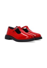 Red patent leather Mary Jane shoes with a T-strap, rounded toe, and a black, low chunk heel. Features a silver buckle accent.