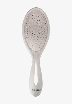 Ovale haarborstel met een gestructureerde witte handgreep, voorzien van een reeks kleine plastic borstels die gelijkmatig over het borsteloppervlak zijn gerangschikt.