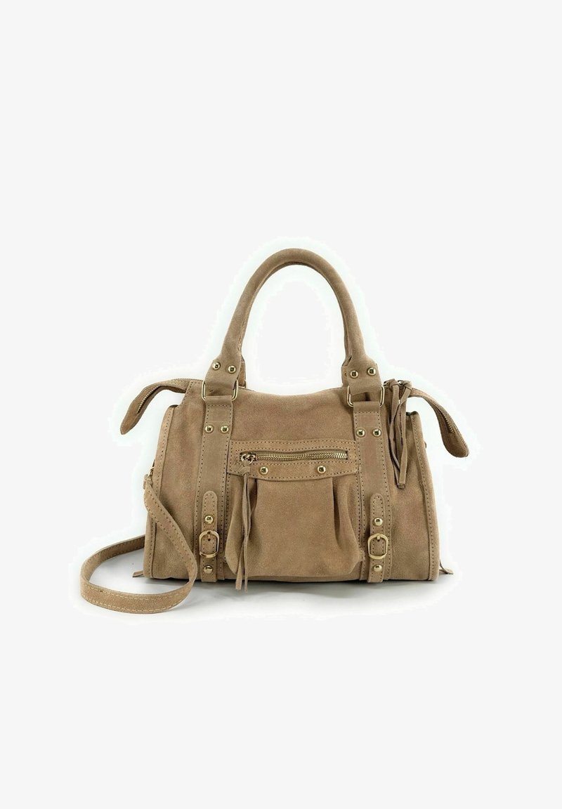 Sac à main en daim beige avec double poignée, bandoulière réglable, poche avant zippée, garnitures dorées et pompons sur les côtés. Design compact et structuré.