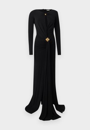 Μαύρο φόρεμα μακρυμάνικο, μάκρος μέχρι το πάτωμα, με σφηκοφωλιά στη μέση, ντεκολτέ-κλειδί και χρυσά διακοσμητικά κούμπωμα στον λαιμό και στη μέση.