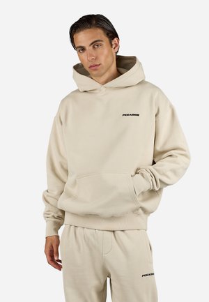 Beige hoodie with a large front pocket, drawstring hood, and small black "PEGAJOR" logo on the chest. Made of soft cotton material.