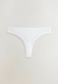Vita stringtrådar i mjukt tyg, med en sömlös design och delikat spetskant längs kanterna, samt en liten rosett som accent.