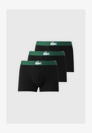 Tre sorte boxershorts med grønne taljebånd, der har en hvid krokodille-logo centralt på hvert taljebånd.